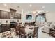 Open concept kitchen, dining, and living room with large windows at 6521 Taffrail Ave, Las Vegas, NV 89118