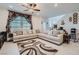 Spacious living room with L-shaped sectional sofa and large TV at 6521 Taffrail Ave, Las Vegas, NV 89118