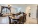 Open-concept living space featuring a round dining table and comfortable living room seating at 6521 Taffrail Ave, Las Vegas, NV 89118