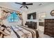 Main bedroom with king-size bed and ensuite bathroom access at 6521 Taffrail Ave, Las Vegas, NV 89118