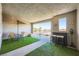 Inviting outdoor patio with seating, artificial turf, and a charming bar area for entertaining at 6521 Taffrail Ave, Las Vegas, NV 89118
