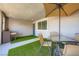 Comfortable patio space with dining area, artificial turf, and outdoor lounging at 6521 Taffrail Ave, Las Vegas, NV 89118
