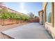 Backyard featuring concrete patio area, trees and brick wall at 7659 Dewy Falls Ave, Las Vegas, NV 89179