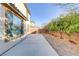 Backyard featuring concrete patio area, trees and brick wall at 7659 Dewy Falls Ave, Las Vegas, NV 89179