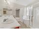The primary bathroom boasts dual sinks, soaking tub, and a separate glass-enclosed shower at 7659 Dewy Falls Ave, Las Vegas, NV 89179