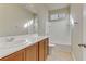 Bright bathroom featuring a large mirror, vanity with storage and a shower-tub combo at 7659 Dewy Falls Ave, Las Vegas, NV 89179