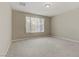 Well-lit bedroom with neutral wall and carpet at 7659 Dewy Falls Ave, Las Vegas, NV 89179