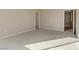 A neutral toned bedroom with carpet flooring has one window and one open doorway at 7659 Dewy Falls Ave, Las Vegas, NV 89179
