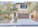 Charming two-story home featuring a well-manicured front yard and a two-car garage at 7659 Dewy Falls Ave, Las Vegas, NV 89179