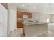 Functional kitchen featuring a breakfast bar, granite countertops, and ample cabinet space at 7659 Dewy Falls Ave, Las Vegas, NV 89179