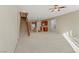 Expansive living area with stairs to upper level with view to kitchen and dining at 7659 Dewy Falls Ave, Las Vegas, NV 89179