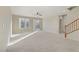 Large open living space with abundant natural light, ceiling fan and neutral carpeting at 7659 Dewy Falls Ave, Las Vegas, NV 89179