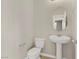 The powder room features a pedestal sink and a standard toilet for guest convenience at 7659 Dewy Falls Ave, Las Vegas, NV 89179
