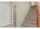 Elegant staircase leading to the upper level of the home at 7659 Dewy Falls Ave, Las Vegas, NV 89179
