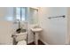 Clean and modern bathroom with pedestal sink and hardwood floors at 78 Sea Holly Way, Henderson, NV 89074