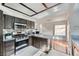 Modern kitchen featuring stainless steel appliances and dark wood cabinets at 78 Sea Holly Way, Henderson, NV 89074