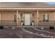 Front view of a tan house with a porch and landscaping at 815 Cram Ave, Logandale, NV 89021