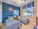 Cozy bedroom with twin beds, blue and white color scheme at 9 Ibis Ct, Henderson, NV 89052