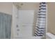 Bathroom with shower/tub, striped curtain, and grab bar at 9009 Careful Canvas Ave, Las Vegas, NV 89149