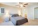 Spacious bedroom with ceiling fan, and gray bedding at 9009 Careful Canvas Ave, Las Vegas, NV 89149
