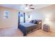 Main bedroom with private balcony access and ceiling fan at 9009 Careful Canvas Ave, Las Vegas, NV 89149