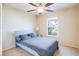 Bedroom with gray bedding, ceiling fan, and window view at 9009 Careful Canvas Ave, Las Vegas, NV 89149