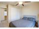 Bedroom with gray bedding, ceiling fan, and closet at 9009 Careful Canvas Ave, Las Vegas, NV 89149