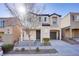 Two-story house with gray siding, attached garage, and small front yard at 9009 Careful Canvas Ave, Las Vegas, NV 89149
