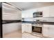 Stainless steel appliances and white cabinetry in this kitchen at 9009 Careful Canvas Ave, Las Vegas, NV 89149