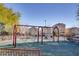 Community playground with swings at 9009 Careful Canvas Ave, Las Vegas, NV 89149