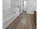 Main bathroom with shower, tub, and wood-look floors at 9133 Black Beauty St, Las Vegas, NV 89113