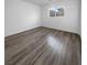 Spacious bedroom with wood-look flooring and window at 9133 Black Beauty St, Las Vegas, NV 89113