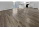 Open living room with modern flooring and kitchen access at 9133 Black Beauty St, Las Vegas, NV 89113