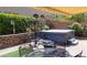 Cozy backyard with a hot tub, outdoor seating, and well-manicured landscaping at 9417 Sand Tiger Ave, Las Vegas, NV 89148