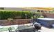 Private backyard featuring a hot tub, outdoor seating, and lush greenery at 9417 Sand Tiger Ave, Las Vegas, NV 89148