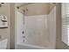 Clean bathroom shower and tub features white tile and chrome shower head at 9417 Sand Tiger Ave, Las Vegas, NV 89148
