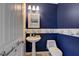 Stylish powder room with pedestal sink and nautical theme at 9417 Sand Tiger Ave, Las Vegas, NV 89148