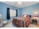 Bedroom featuring blue walls, a white ceiling fan, and white frame bed at 9417 Sand Tiger Ave, Las Vegas, NV 89148