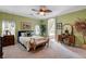 Relaxing main bedroom with a ceiling fan, large windows and en-suite bathroom at 9417 Sand Tiger Ave, Las Vegas, NV 89148