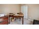 Office space with a wooden desk, cabinets, and a large closet at 9417 Sand Tiger Ave, Las Vegas, NV 89148