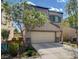 Two-story house with tan siding, stone accents, and a two-car garage at 9417 Sand Tiger Ave, Las Vegas, NV 89148