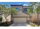 Two-story house with tan siding, stone accents, and a two-car garage at 9417 Sand Tiger Ave, Las Vegas, NV 89148