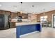 Modern kitchen with dark wood cabinets, granite countertops, and a large island at 9417 Sand Tiger Ave, Las Vegas, NV 89148