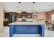 Modern kitchen with dark wood cabinets, granite countertops, and a large island at 9417 Sand Tiger Ave, Las Vegas, NV 89148