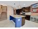 Modern kitchen with dark wood cabinets, granite countertops, and a large island at 9417 Sand Tiger Ave, Las Vegas, NV 89148