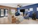 Living room with blue accent wall, fireplace, and comfortable seating at 9417 Sand Tiger Ave, Las Vegas, NV 89148
