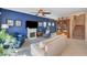 Spacious living room with blue walls, fireplace, and built-in bookcase at 9417 Sand Tiger Ave, Las Vegas, NV 89148