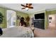 Spacious main bedroom with a fireplace, TV, desk, ceiling fan, and doorway to the en suite at 9417 Sand Tiger Ave, Las Vegas, NV 89148