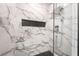 Modern bathroom with marble shower and hexagon floor tiles at 10009 Cabernet Hills St, Las Vegas, NV 89141