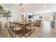 Open concept dining room with wood table and modern chandelier at 10009 Cabernet Hills St, Las Vegas, NV 89141